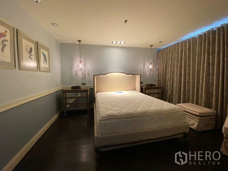 Condominium for rent in Khlong San, Bangkok - Bedroom with upholstered bed, pendant lights and full‑height curtains.