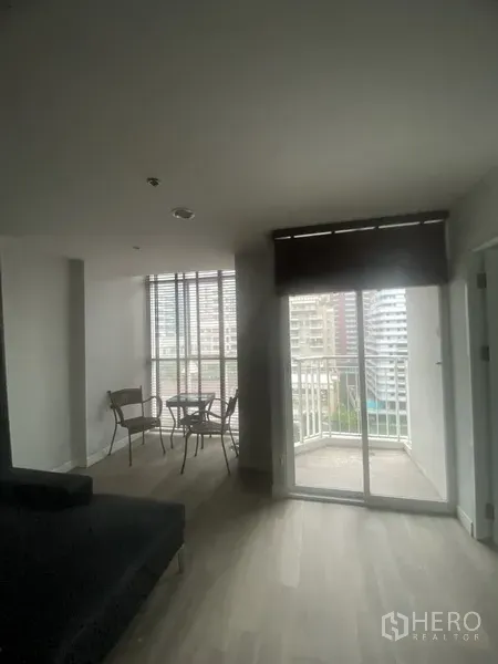 公寓 出租在Pathum Wan, Bangkok - 起居与用餐区连接推拉门阳台，可观城市天际线，靠近BTS Chitlom站。