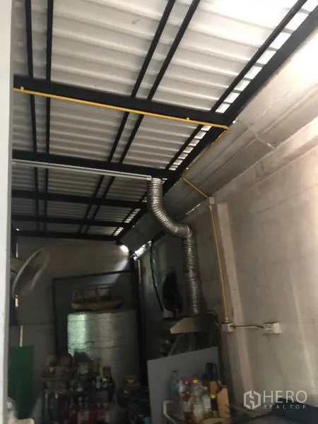 Townhouse for sale in Phasi Charoen, Bangkok - Roofed utility zone with metal beams and ventilation ducting.