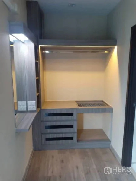 Detached House for rent in Thanyaburi, Pathum Thani - Custom built-in dressing area with drawers, open shelves, and warm under-cabinet lighting.