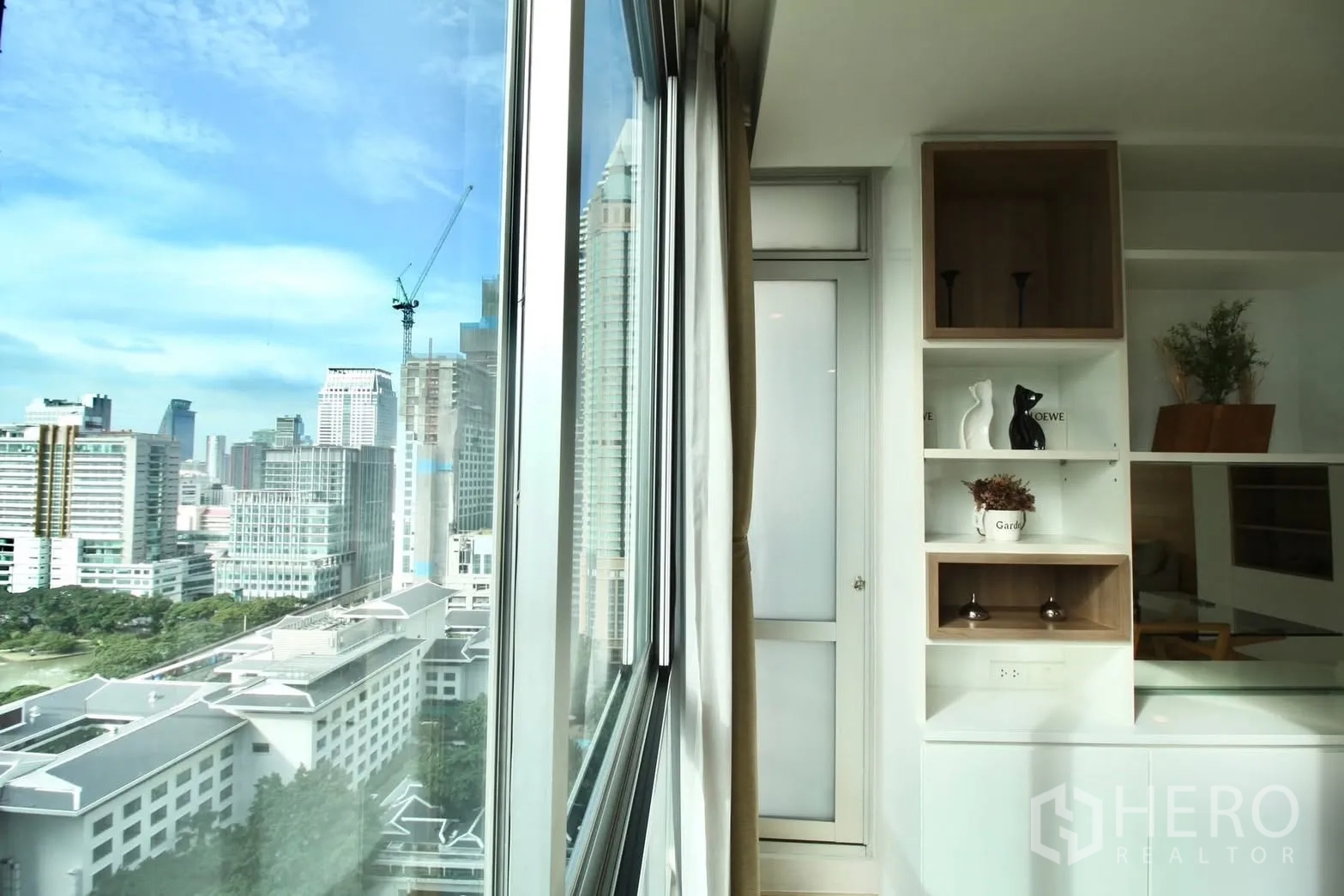 คอนโด for rent in Pathum Wan, Bangkok - วิวสกายไลน์เมืองจากหน้าต่างบานใหญ่ข้างตู้บิลท์อินภายในคอนโด