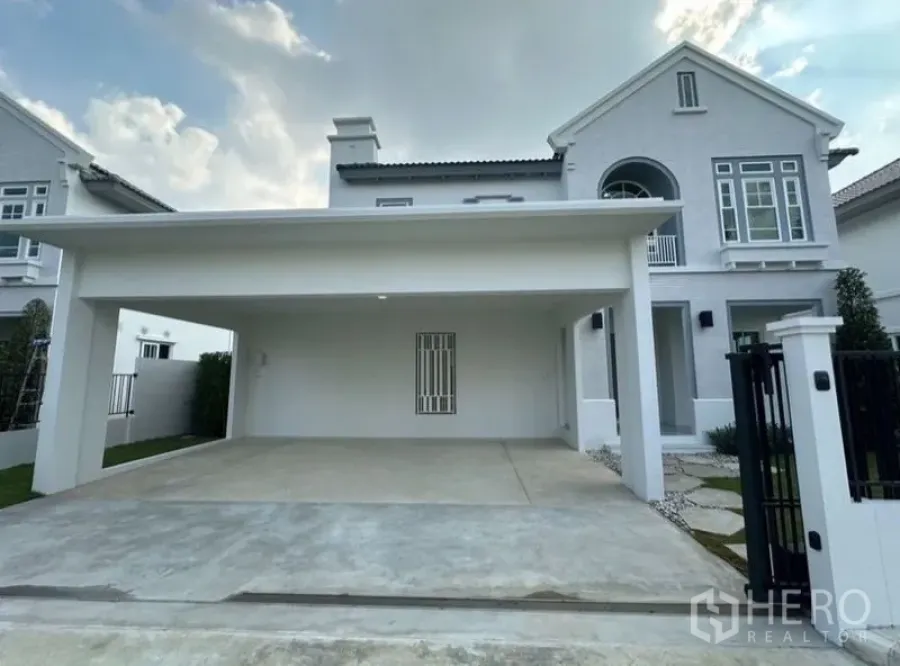 Detached House for rent - Front exterior of a white two-storey detached house with a covered double carport and gated driveway.