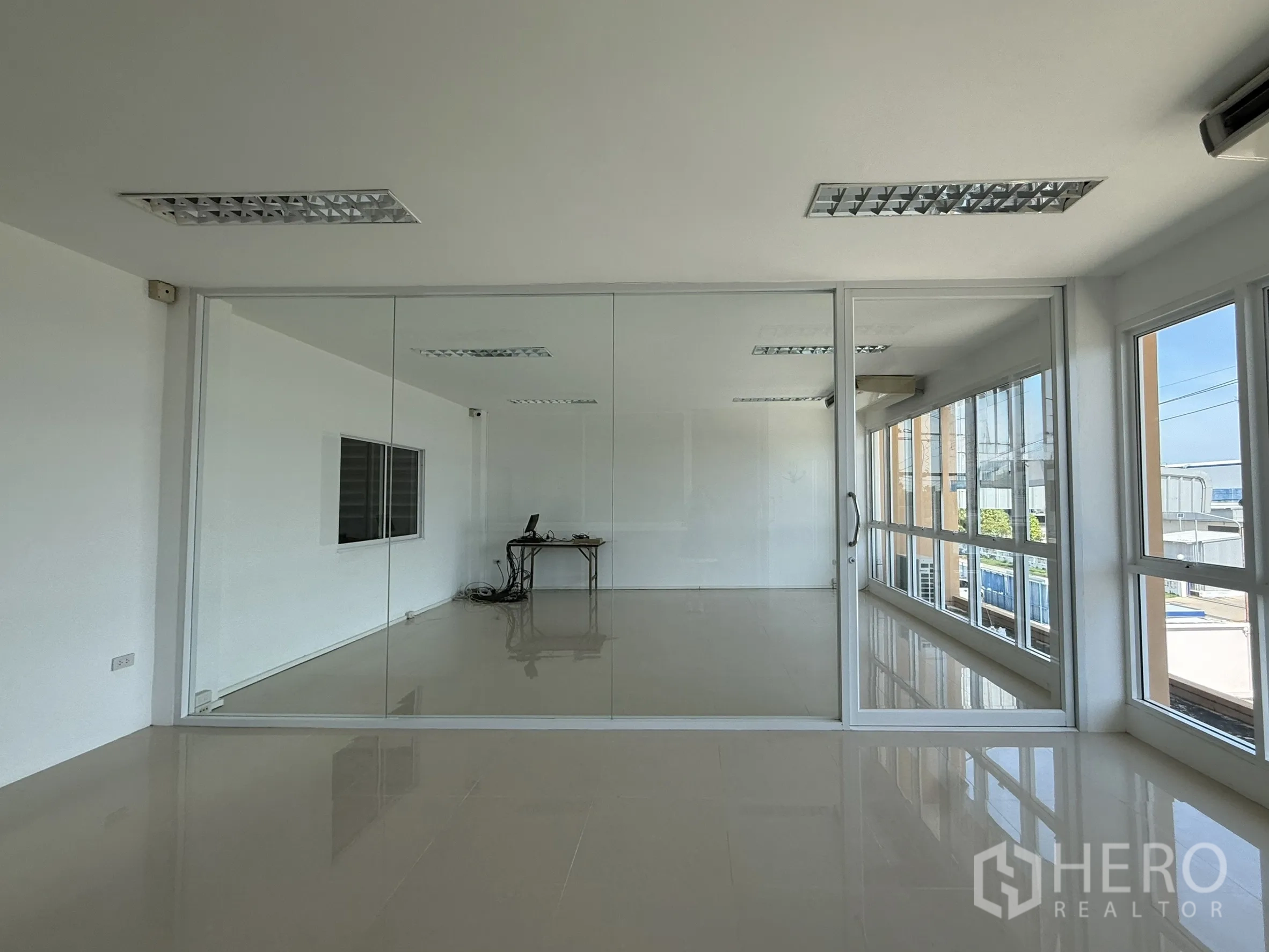 Warehouse for rent or sale in Bang Bo, Samut Prakan - Second‑floor glass meeting room with full‑height windows overlooking the yard.