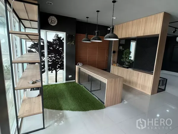 Detached House for rent or sale in Don Mueang, Bangkok - Ground floor reception with wood counter, shelving and glass wall with turf.