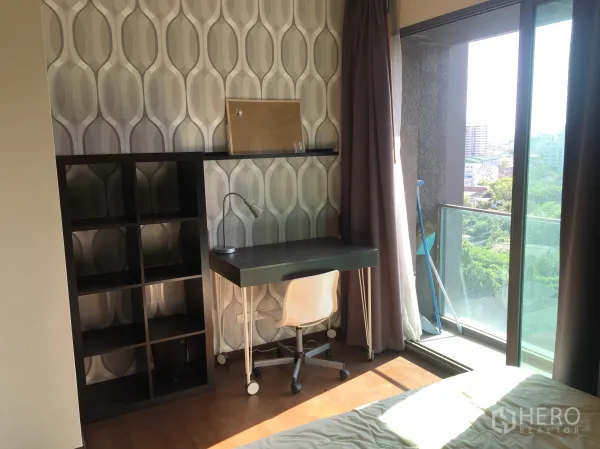 คอนโด ให้เช่าในKhlong Toei, Bangkok - ห้องนอนมีโต๊ะทำงาน ชั้นวางของ และประตูกระจกออกระเบียงมองเห็นวิวสีเขียวของเมือง