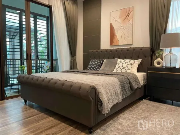Detached House for rent in Bang Kapi, Bangkok - Master bedroom with upholstered king bed, balcony access and floor-to-ceiling curtains.
