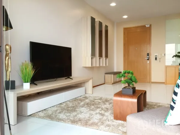 คอนโด ให้เช่าหรือขายในKhlong Toei, Bangkok - ผนังทีวีจอใหญ่พร้อมตู้เก็บของและประตูเข้าห้องในโซนรับแขก