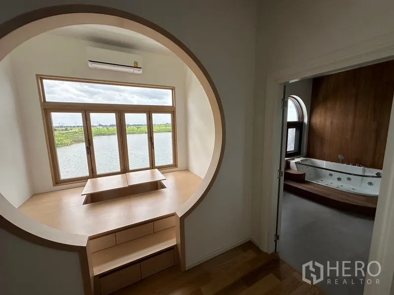 Detached House for sale in Sai Noi, Nonthaburi - Circular bay window seating with lake view beside doorway to a spa bathroom with jacuzzi.