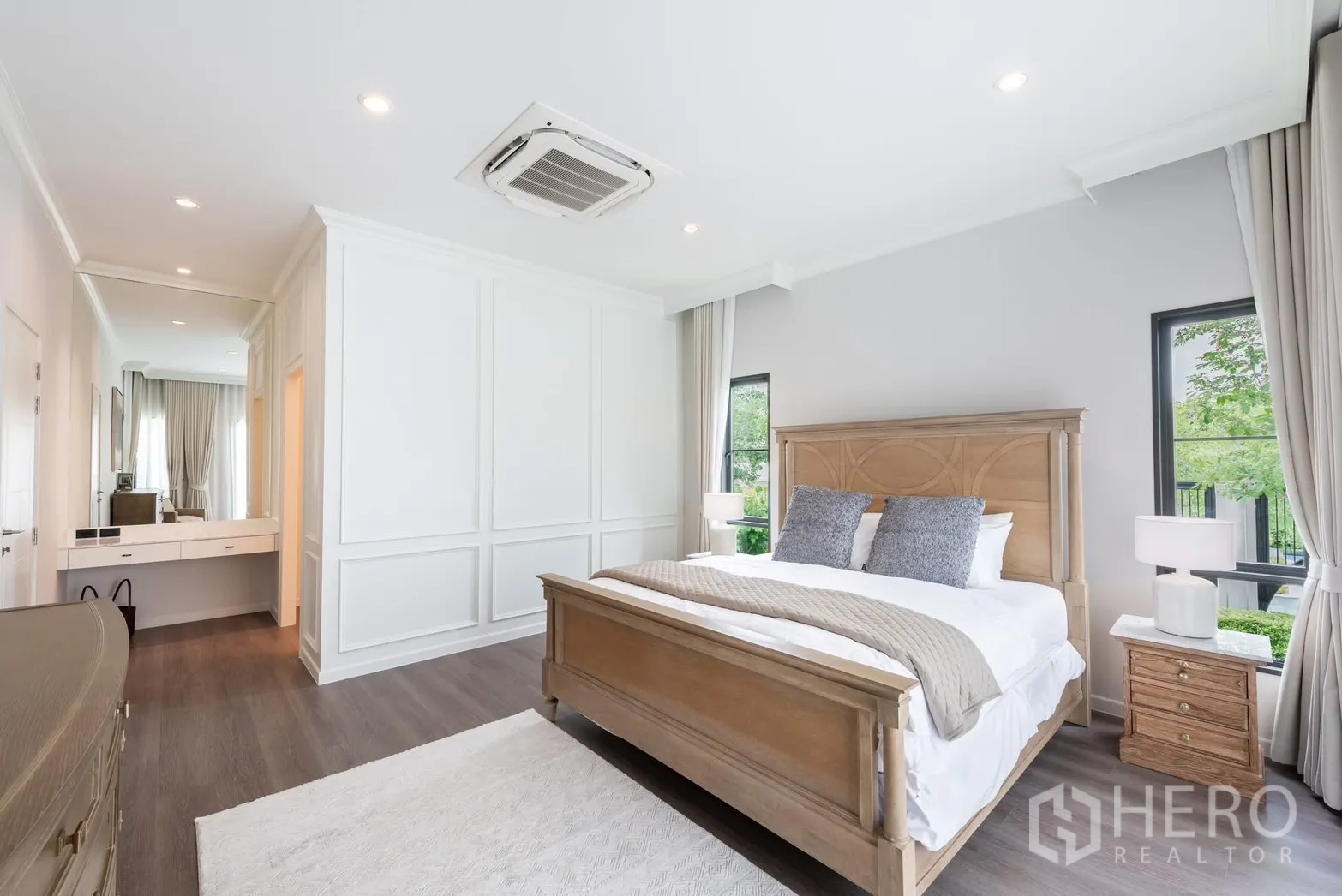 Detached House for rent or sale in Bang Phli, Samut Prakan - Master bedroom with wood bed, full-height curtains, and ceiling cassette AC.
