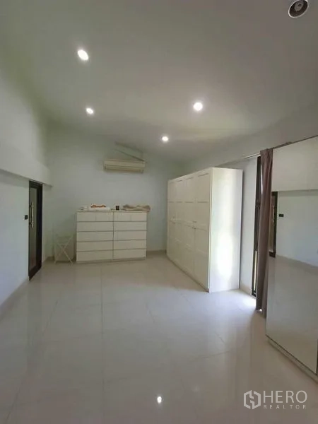 Home Office for rent in Watthana, Bangkok - Bright dressing room with white cabinetry and air conditioner.
