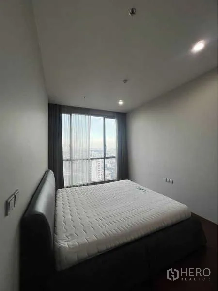 公寓 出售在Watthana, Bangkok - 主卧配大床与大窗，可欣赏城市景。