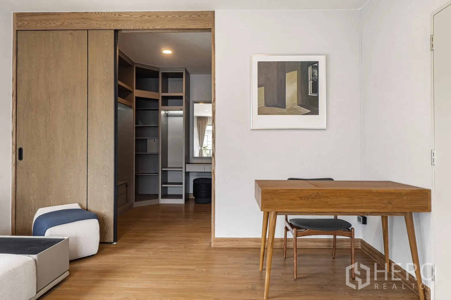 Detached House for rent in Bang Phli, Samut Prakan - Home office area with wood desk opening to a built-in walk-in closet with shelving.