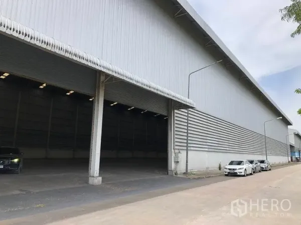 货栈 出租在Phra Nakhon Si Ayutthaya - 仓库立面设有带雨棚的装卸月台，车道宽阔便于卡车进出。