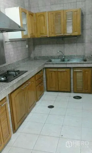 ทาวน์เฮาส์ ให้เช่าในSuan Luang, Bangkok - ครัวรูปตัวแอล ตู้ไม้ เคาน์เตอร์หินแกรนิต เตาแก๊ส เครื่องดูดควัน และอ่างล้างจานสเตนเลส