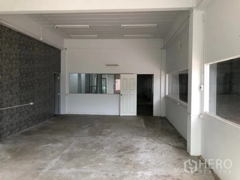 คลังสินค้า ให้เช่าในKhlong Sam Wa, Bangkok - ห้องทำงานหรือห้องเก็บของชั้นล่าง มีหน้าต่าง ประตู และพื้นคอนกรีต