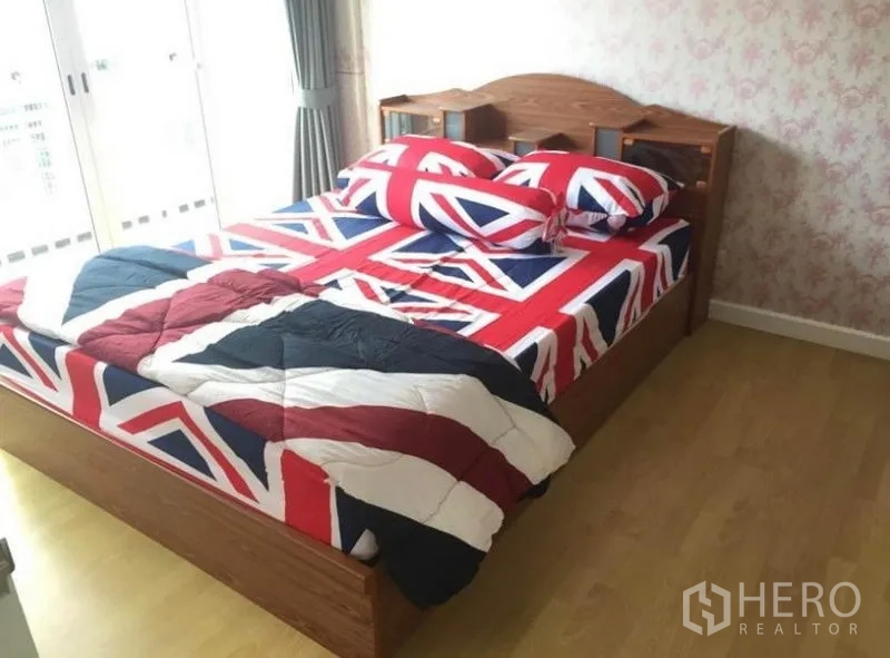 联排别墅 出租在Prawet, Bangkok - 采光充足的卧室，木床，花纹背景墙，推拉门通向阳台。