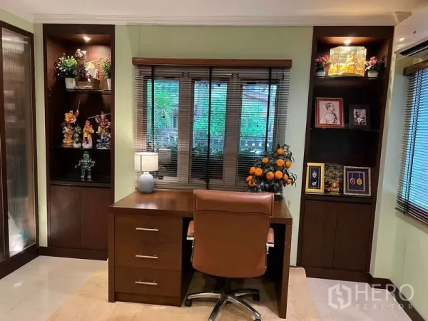 Detached House for sale in Bueng Kum, Bangkok - Home office with wooden desk, shelving, and garden views through the windows.