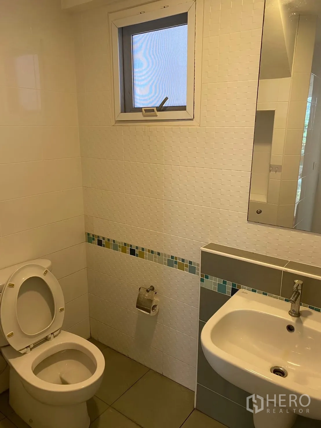 Detached House for rent in Prawet, Bangkok - Bathroom with white tiles, sink, and toilet.