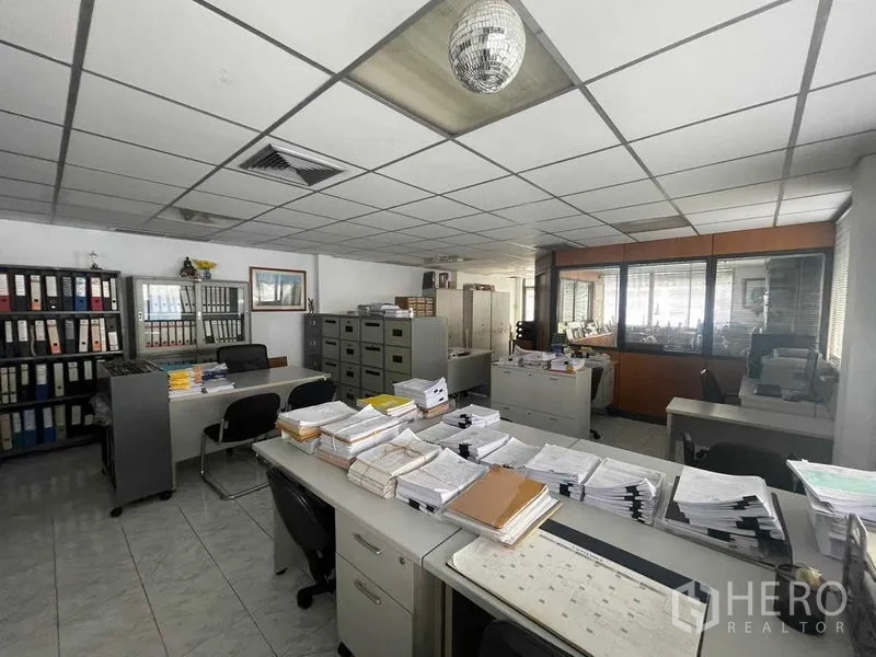 店屋 出租在Phaya Thai, Bangkok - 开放式办公室空间，摆放办公桌与档案柜，靠近BTS阿里站。