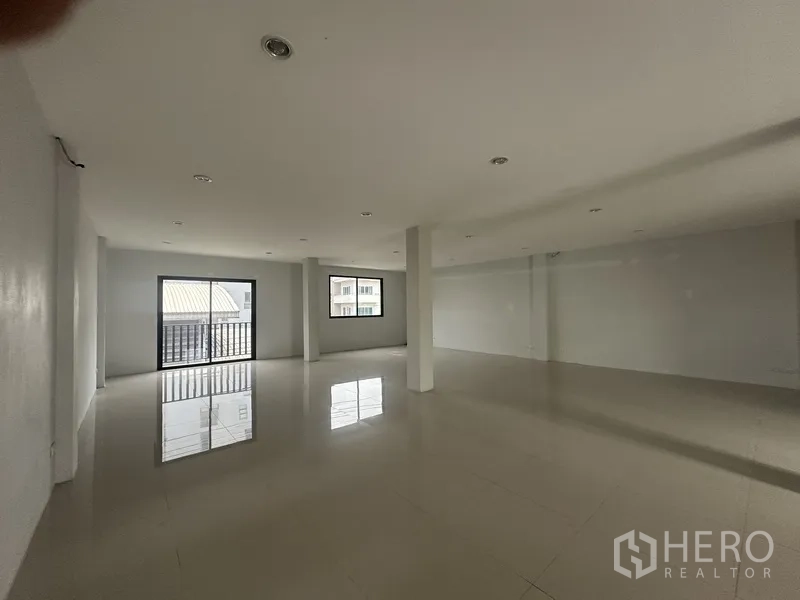 Home Office for rent or sale in Khlong Toei, Bangkok - Large open‑plan office level with glossy tile floors and windows providing natural light.