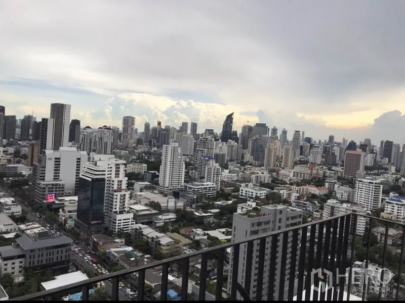 Condominium for rent or sale in Watthana, Bangkok - High-floor balcony view over the Bangkok skyline and city buildings.