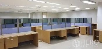 Office Space for rent or sale - Spacious workstation area with multiple desks and low glass partitions near MRT Khlong Toei.
