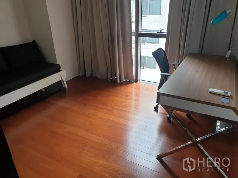 คอนโด ให้เช่าในPathum Wan, Bangkok - ห้องอเนกประสงค์จัดเป็นโฮมออฟฟิศ มีโต๊ะทำงาน เก้าอี้ พื้นไม้ และหน้าต่างบานสูงพร้อมผ้าม่าน