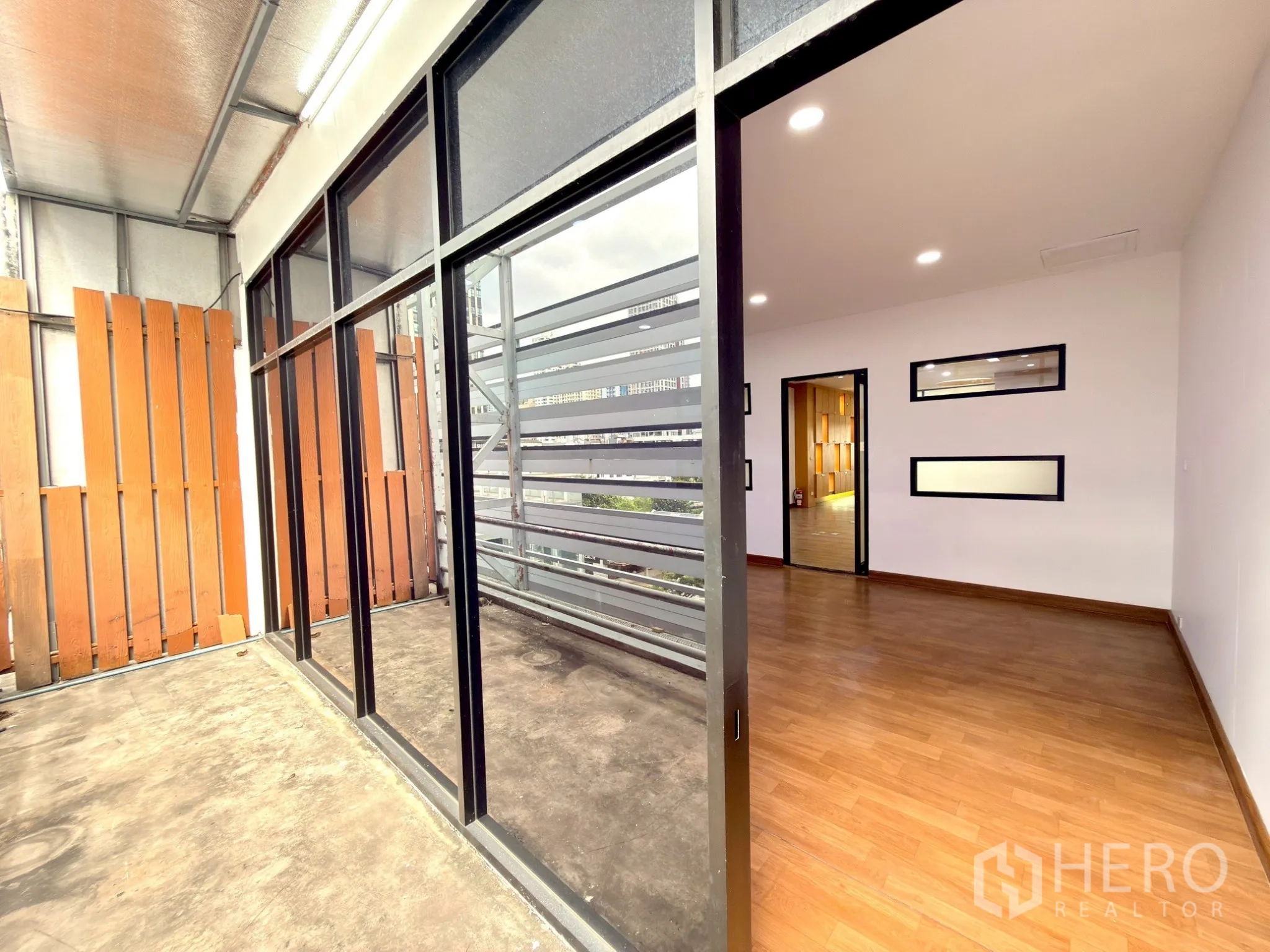 Office Space for rent in Watthana, Bangkok - Covered balcony with sliding glass doors and slatted screen beside the office.