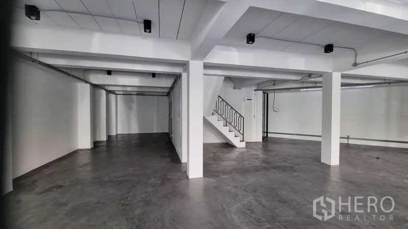 อาคารพาณิชย์ ให้เช่าในKhlong Toei, Bangkok - พื้นที่ชั้นล่างแบบโอเพนสเปซ พื้นขัดมัน เสาโครงสร้างสีขาว และเดินระบบลอยเพดาน.