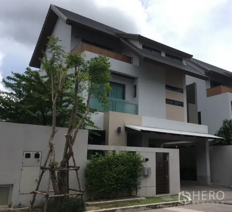 Detached House for rent or sale in Bang Kapi, Bangkok - Front elevation of three-storey detached house with carport and garden.
