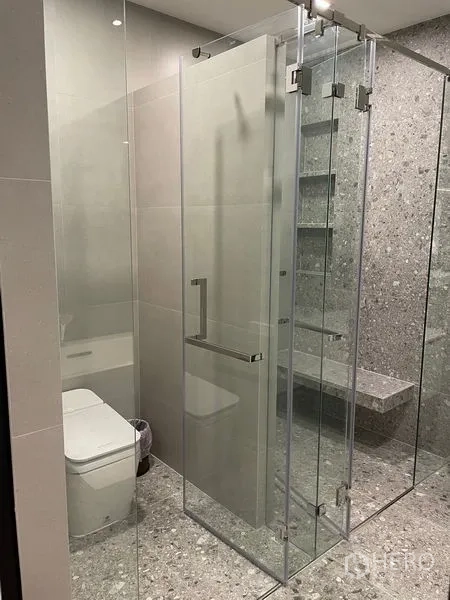 Detached House for sale in Saphan Sung, Bangkok - Contemporary bathroom with frameless glass shower, terrazzo tiles and a modern toilet.
