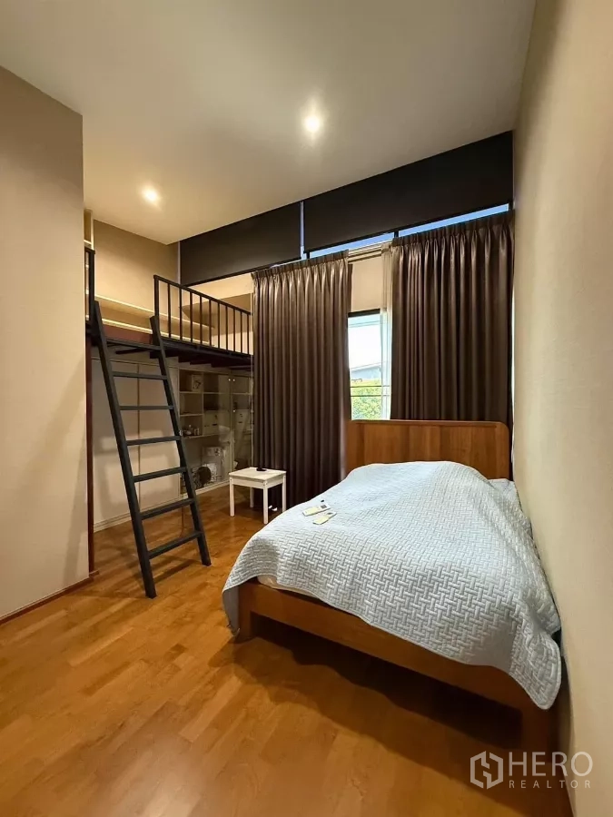 Detached House for rent or sale in Bueng Kum, Bangkok - Bedroom with mezzanine loft, ladder access, standard bed below, shelving and window with blackout curtains.
