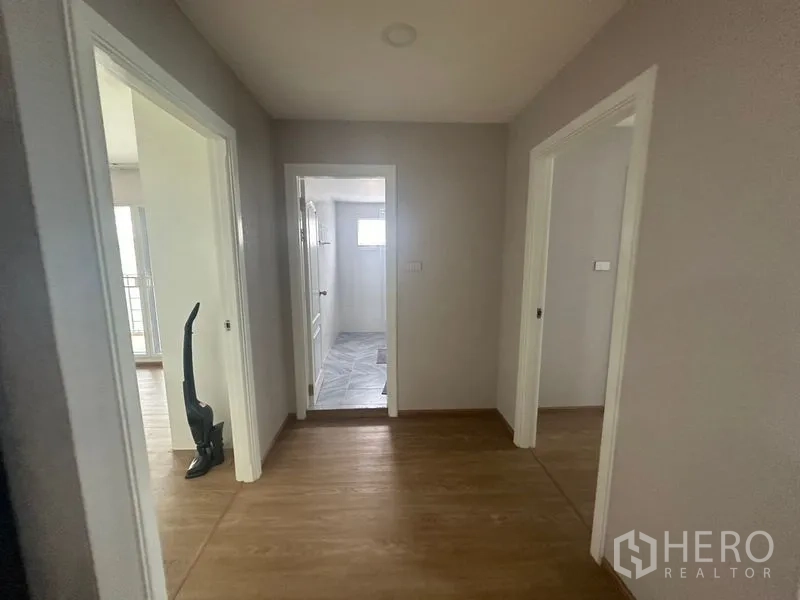 Condominium for rent - Hallway with wood floors connecting bedrooms and a bathroom.