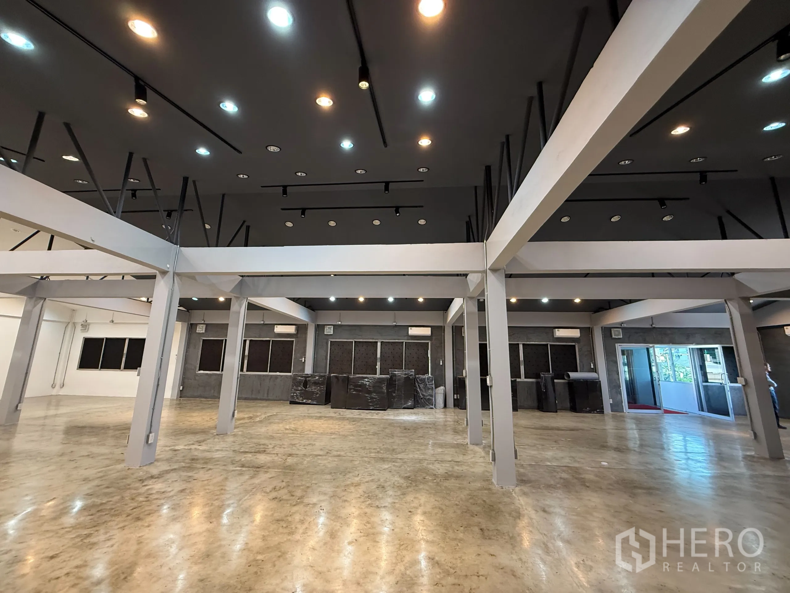 Office Space for rent in Wang Thonglang, Bangkok - Ceiling lights and beams above an open-plan area, close-up view.
