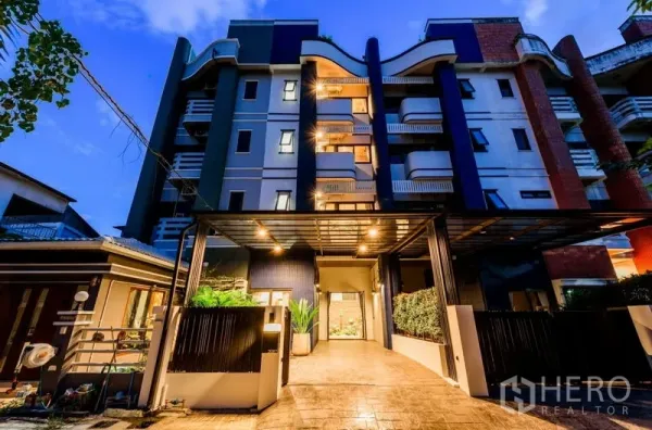 Home Office for rent or sale - Evening exterior of the multi-storey building with balconies and lights.