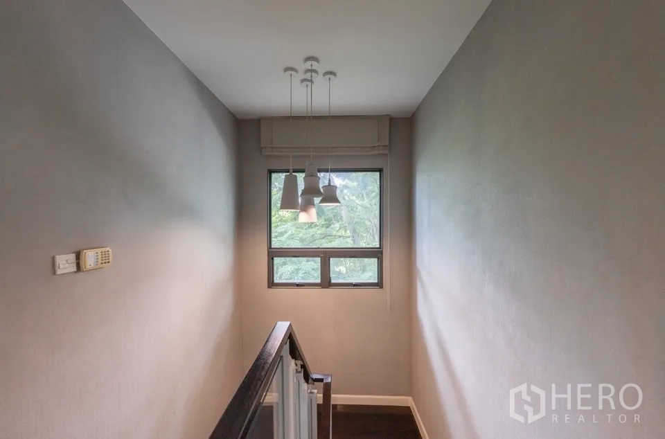 Detached House for rent or sale in Bang Kapi, Bangkok - Stair landing with pendant lights and window.