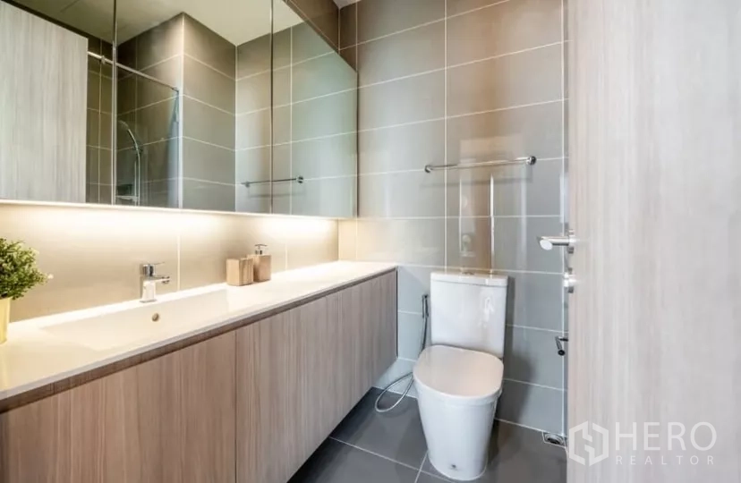 คอนโด ให้เช่าในChatuchak, Bangkok - ห้องน้ำที่สอง เคาน์เตอร์ยาว อ่างล้างหน้า กระจกบานใหญ่ และไฟซ่อน.