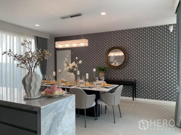 Detached House for rent in Bang Kapi, Bangkok - Dining area view showing chandelier, textured wallpaper and floor‑to‑ceiling curtains.