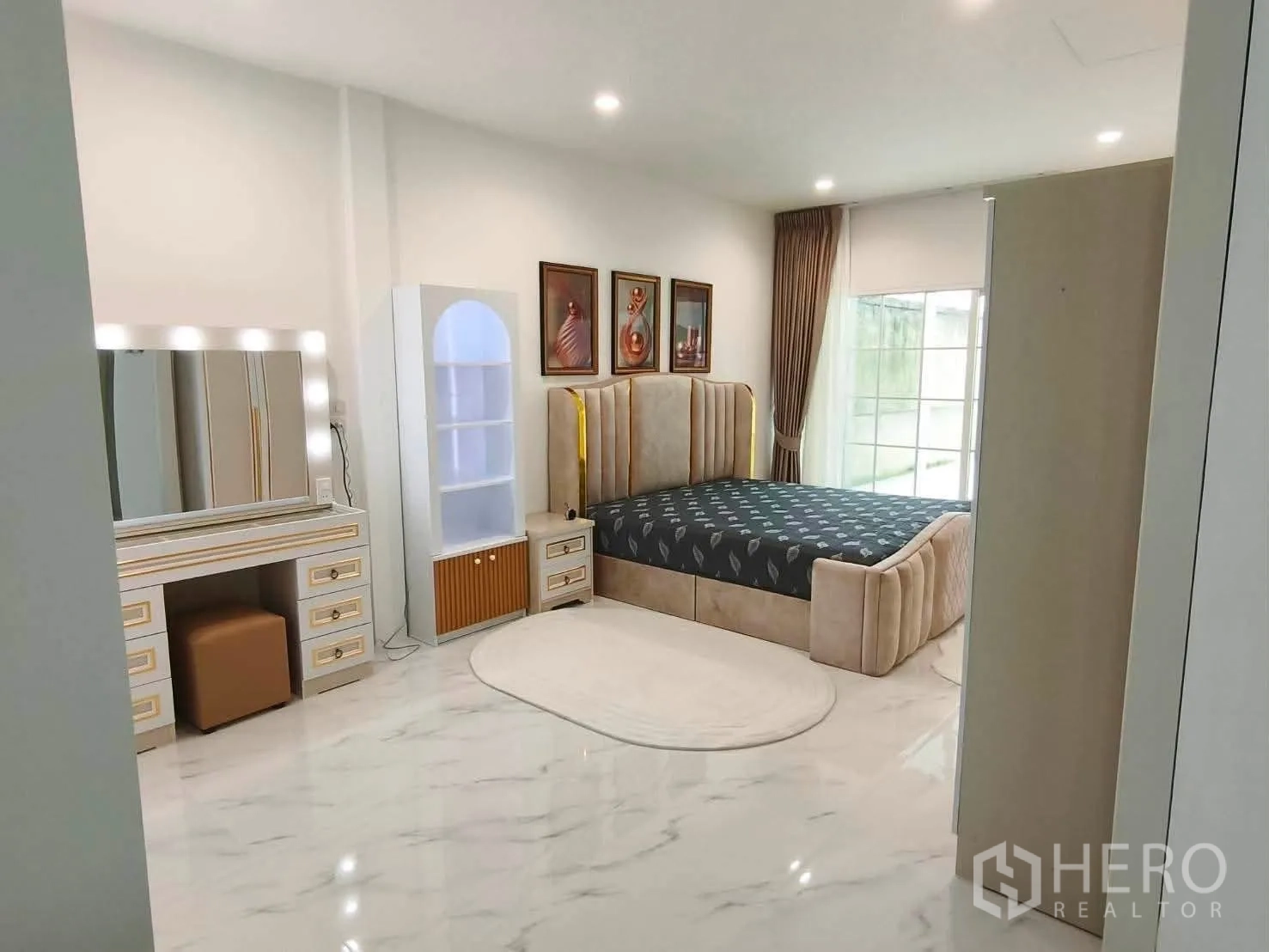 Detached House for rent in Bang Phli, Samut Prakan - Spacious bedroom with marble-look floor, vanity set and bed.