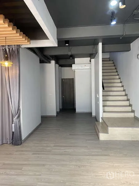 Home Office for rent or sale - Open-plan area with staircase, exposed ceiling and floor-to-ceiling drapes.