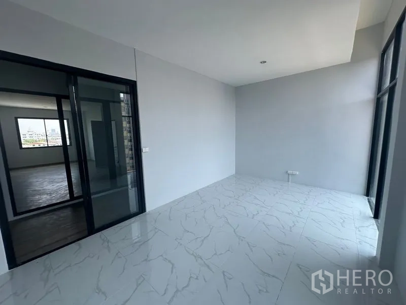 Home Office for rent - Bright glass-enclosed room with marble tiles and a sliding door connection.