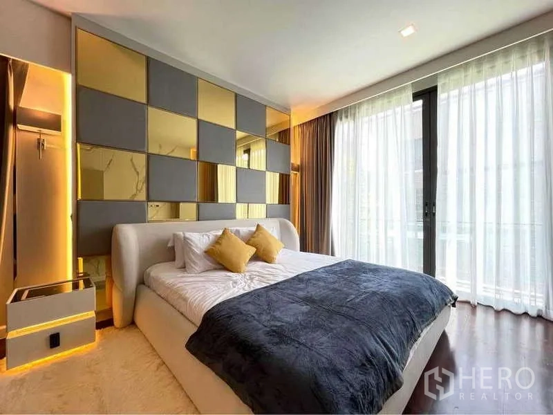 Detached House for rent in Bang Sue, Bangkok - Bedroom with gold and gray paneled headboard and balcony curtains.