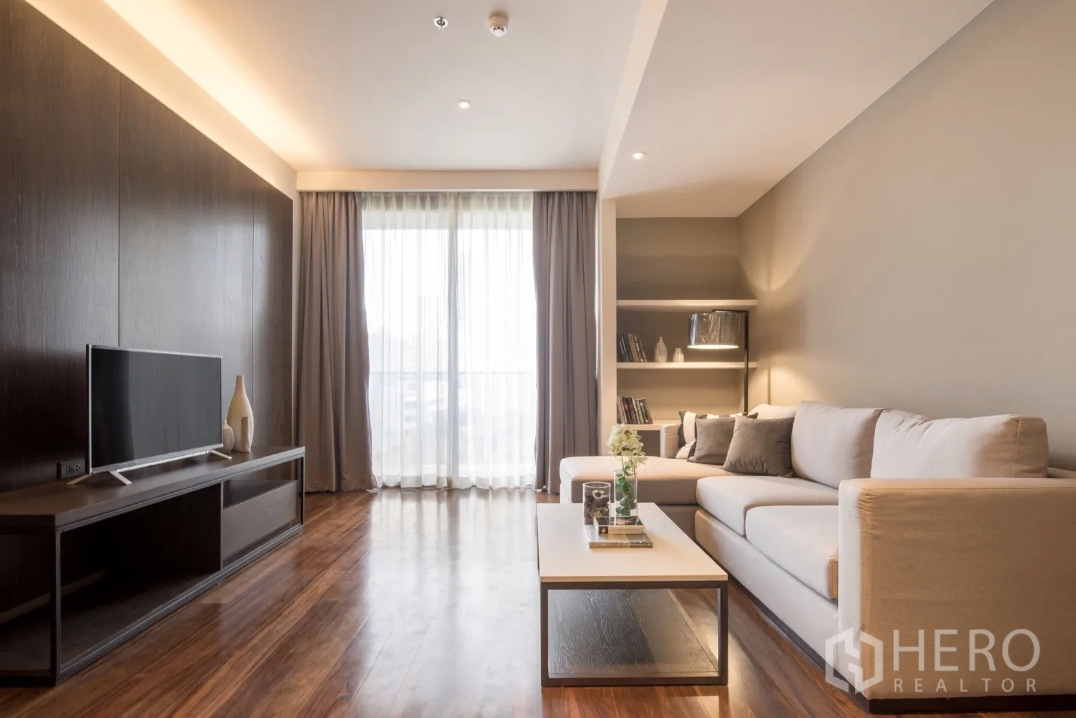 คอนโด for rent in Khlong Toei, Bangkok - มุมนั่งเล่นสไตล์โมเดิร์น พร้อมชั้นบิลท์อิน ชั้นวางทีวี และผ้าม่านโปร่งรับแสงธรรมชาติ