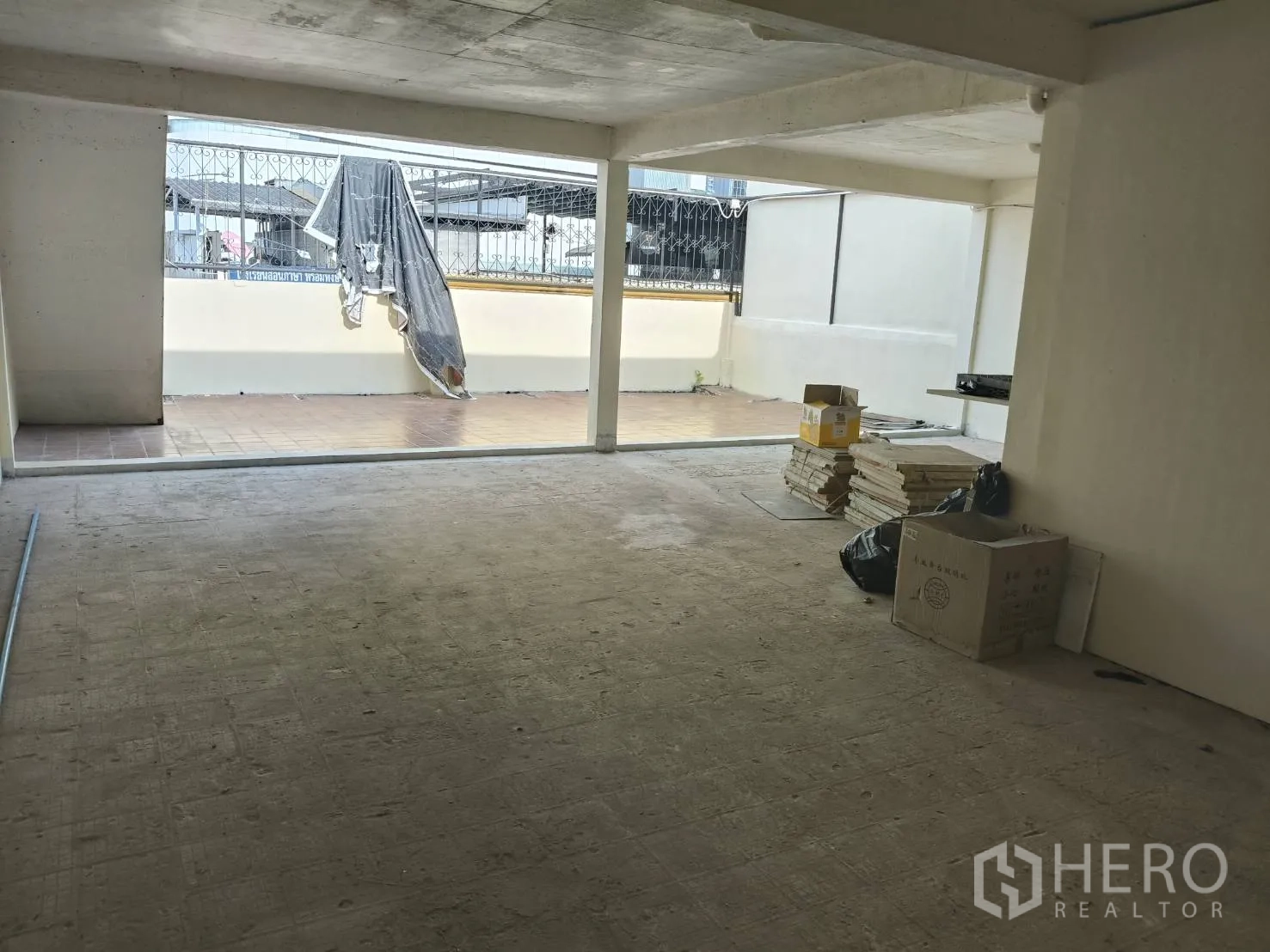 Retail Space for rent in Watthana, Bangkok - Covered workspace or storage area opening to an outdoor tiled patio.