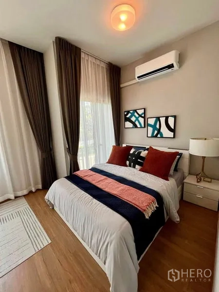 Townhouse for sale in Sai Mai, Bangkok - Corner bedroom with large windows, air conditioning, and stylish decor.