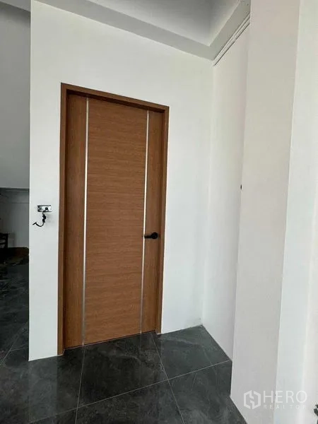 Home Office for rent in Don Mueang, Bangkok - Interior corridor featuring a wooden door against white walls and dark floor tiles.