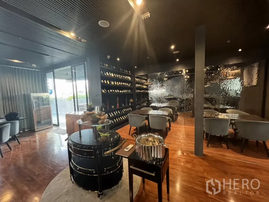 Retail Space for rent - Stylish restaurant dining room with wine wall, grey chairs and wood flooring.