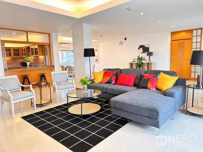 Apartment for rent - Open-plan lounge connecting to the kitchen pass-through and dining zone.