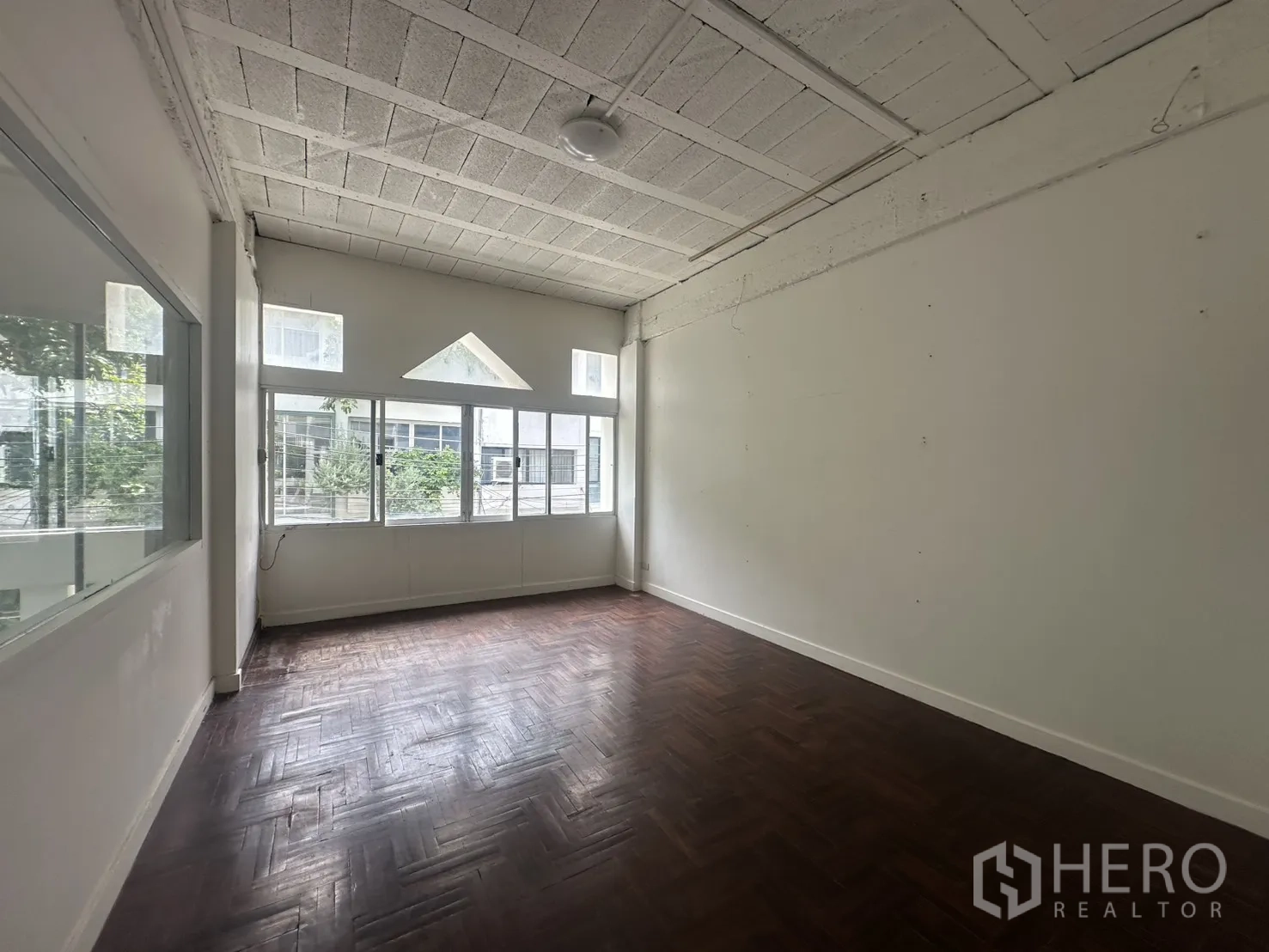 Home Office for rent in Watthana, Bangkok - Room with parquet floor and feature windows allowing natural light.