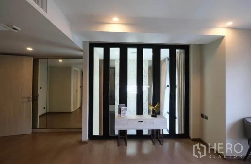 คอนโด ให้เช่าในPathum Wan, Bangkok - พื้นที่ชั้นบนกั้นด้วยกระจกกรอบดำและโต๊ะคอนโซล